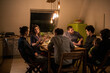 © Malte Jager/Westend61 - Male and female friends talking during dinner at home