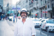 © Oscar Carrascosa Martinez/Westend61 - Portrait of attractive senior man with white clothing and hat posing at camera in street of Madrid