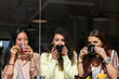 © NOVELLIMAGE/Westend61 - Female friends drinking coffee together at cafe