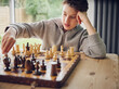 © Phillip Waterman/Westend61 - Intelligent boy playing chess at home