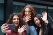 © NOVELLIMAGE/Westend61 - Cheerful friends waving hand to video call on mobile phone