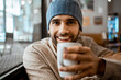 © Rafa Cortes/Westend61 - Happy mid adult man holding coffee cup in cafe