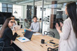 © SERGIO NIEVAS/Westend61 - Male and female professionals looking at businesswoman gesturing during meeting in office