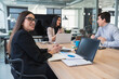 © SERGIO NIEVAS/Westend61 - Businesswoman looking away while male and female colleague discussing at conference table in office