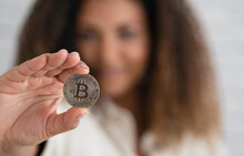 Young Woman Showing Silver Bitcoin