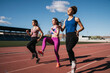 © CSSHOT/Westend61 - Young female sportswomen exercising on sports track