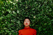 © Tania Cervian/Westend61 - Woman with eyes closed in front of green plants