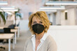 © Xavier Lorenzo/Westend61 - Businesswoman wearing protective face mask in office during pandemic