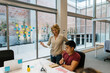 © Xavier Lorenzo/Westend61 - Male and female entrepreneurs discussing over business plan at desk in office