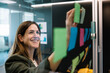 © Xavier Lorenzo/Westend61 - Excited businesswoman brainstorming using sticky notes on glass wall at office