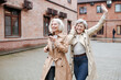© Katharina und Ekaterina/Westend61 - Happy female friends sharing headphones while listening music and dancing