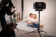 © Francesco Buttitta/Westend61 - Couple with cake kissing while doing photo shoot in studio