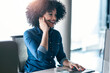© JOSEP SURIA/Westend61 - Smiling female customer service representative talking through headphones at desk in office