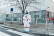 © Eugenio Marongiu/Westend61 - Young female astronaut in space suit standing near zebra crossing outside building in city