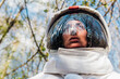 © Eugenio Marongiu/Westend61 - Female explorer with space helmet in forest