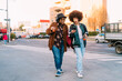 © Eugenio Marongiu/Westend61 - Young women using mobile phone while walking on phone