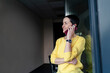 © Oxana Guryanova/Westend61 - Smiling businesswoman contemplating while talking on smart phone in modern office