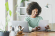 © steve brookland/Westend61 - Smiling woman checking document while working at home