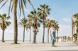 © Xavier Lorenzo/Westend61 - Mid adult woman skating by palm tree on footpath