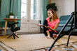 © Xavier Lorenzo/Westend61 - Young female influencer vlogging while exercising at home