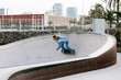 © Xavier Lorenzo/Westend61 - Mid adult woman skateboarding in park