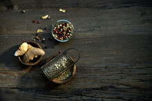 Bowls With Ginger Root, Old Grater And Various Peppercorns Lying On Wooden Surface