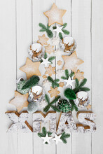 Arrangement Of Homemade Cookies And Various Christmas Decorations Hanging On Wooden Wall