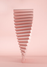 Three Dimensional Render Of Stack Of Pink Geometric Cylinders Balancing Against Pink Background