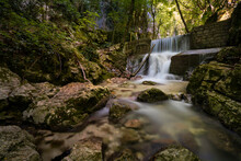 Long Exposure Of Small Forest Waterfall In Monte Cucco Park, Umbria, Italy