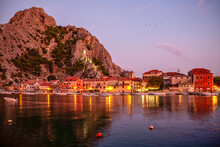 Croatia, Split-Dalmatia County, Omis, Coastal Town Situated At Confluence Of Adriatic Sea And Cetina river At Dusk