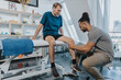 © Mareen Fischinger/Westend61 - Male physiotherapist checking out knee of patient in practice