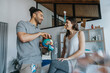 © Mareen Fischinger/Westend61 - Smiling male physical therapist explaining skull model to female patient in practice