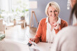 © Uwe Umstatter/Westend61 - Smiling female entrepreneur looking at colleague while working in home