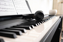 Wireless Headphones On Piano Keyboard