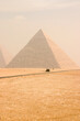 View of the Great Pyramids of Giza in Cairo Egypt on a hazing morning 