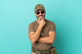 Fototapeta  - Military with dog tag over isolated on blue background with glasses and smiling