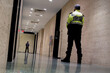 © Tomo Nogi1/Wirestock - Low angle shot of security guards patrolling inside commercial b