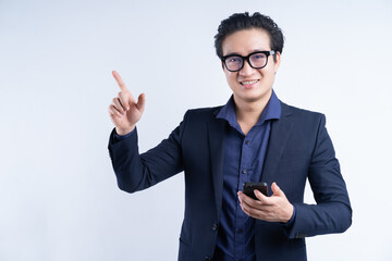 Portrait of Asian businessman standing using phone
