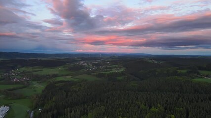 Canvas Print - An aerial shot of beautiful landscape field under a cloudy sky during sunset in 4K