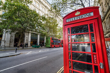 Sticker - London, the UK. Red phone booth and red bus in background. English icons