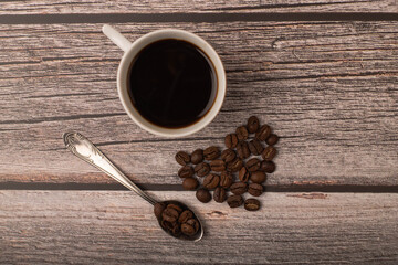 dark coffee and grains on wooden background