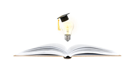 learning and idea concept. glowing light bulb with a graduate cap above an open book