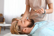 © Pixel-Shot - Reiki master working with patient