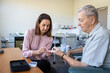 © Austockphoto - female health professional consulting with elderly male patient