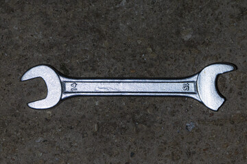 Shining broken wrench. Work tool failure On cement floor