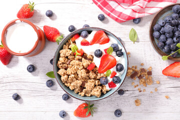 Wall Mural - bowl of muesli, berries fruit and yogurt