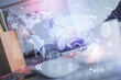 © peshkova - Double exposure of woman hands working on computer and world map hologram drawing. International technology business concept.