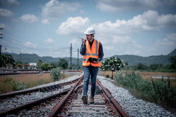 Canvas Print - Engineer under inspection and checking construction process railway switch and checking work on railroad station .Engineer wearing safety uniform and safety helmet in work.