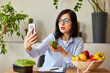 Nutritionist, dietitian woman recording on a smart phone her vlog about healthy eating
