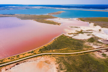 Poster - Aerial view of a road amid a crimson salt lake and other small lakes in Altai